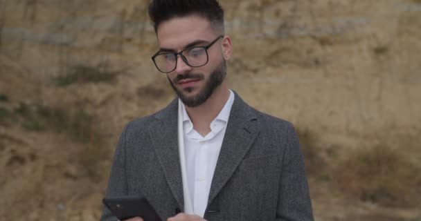 Excited Young Bearded Man Glasses Holding Phone Smiling Reading Messages — Stock Video