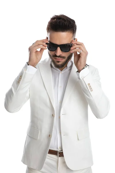 Sexy Businessman Arranging His Sunglasses Style White Studio Background — Stock Photo, Image