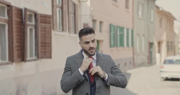 セクシーなビジネスマンがネクタイをしてコートを閉じて歩きます — ストック動画