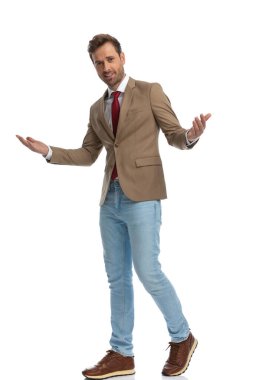 handsome businessman welcoming someone with his hands wide open and a smile on his face