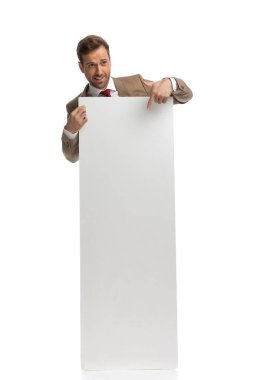 young handsome businessman pointing to his board with enthusiasm against white background