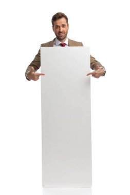 attractive businessman pointing to his empty board and feeling excited against white background