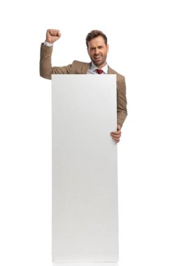 excited businessman celebrating success and showing his vertical blank board against white background