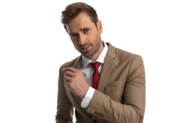 young businessman posing with one hand up and a sensual look on his face against white background