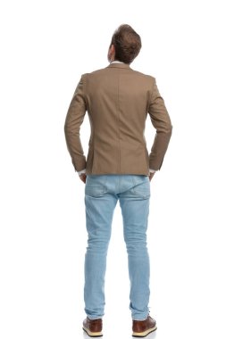 rear view of a businessman showing his back to the camera and looking up to check something