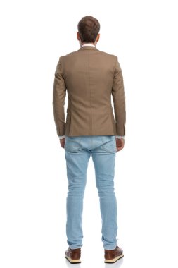 rear view of a businessman looking away from the camera and posing against white background