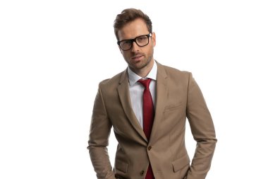 cool smart casual man posing in his nice suit and wearing eyeglasses against white background