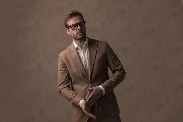 Sexy Tough Businessman Rubbing His Palms Wearing Eyeglasses Looking Away — Stockfoto