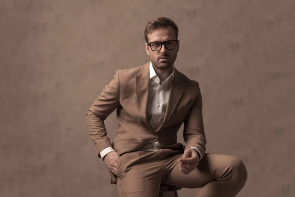 Seated Cool Fashion Model Posing One Hand Pocket Wearing Eyeglasses — Photo