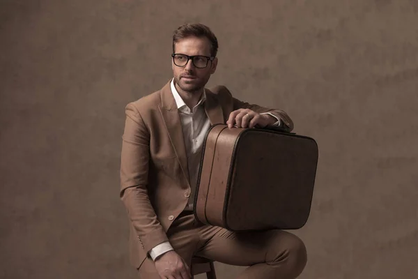 Seated Cool Businessman Holding His Briefcase Looking Side Wearing Eyeglasses — Fotografia de Stock