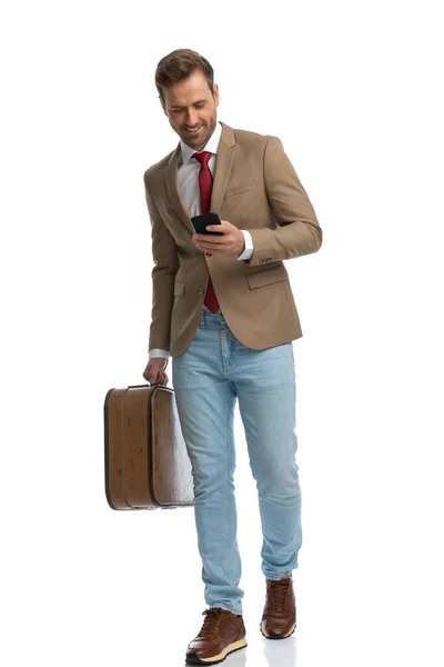 Handsome Businessman Writing Message His Phone While Walking Holding Briefcase — Zdjęcie stockowe