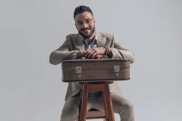 Happy Young Businessman Smiling Holding Arms Suitcase While Sitting Grey — Stok fotoğraf