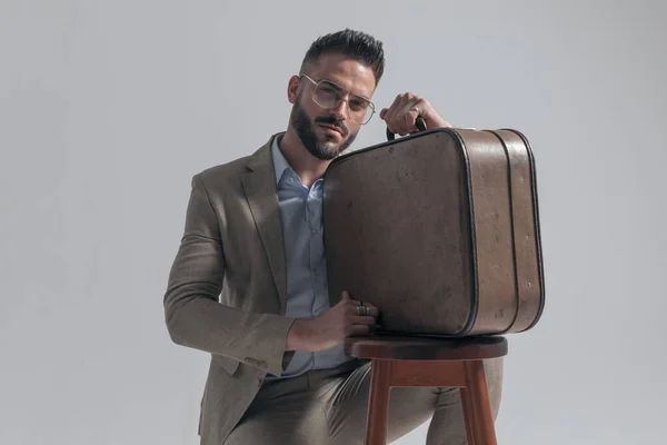 Portrait Sexy Man Crouching Holding Suitcase Wooden Chair While Posing — Stok fotoğraf