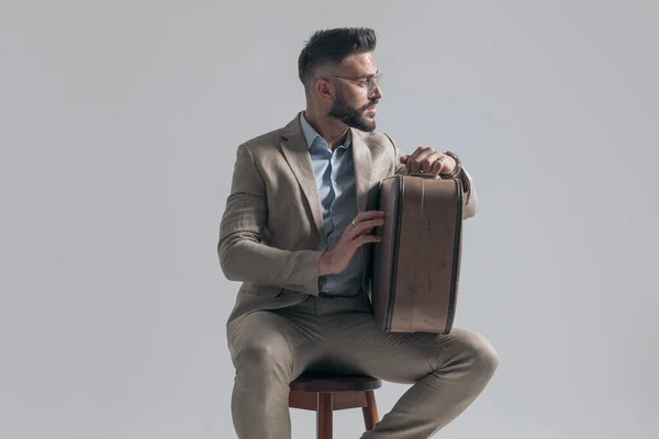 Cool Young Model Suit Glasses Looking Side Holding Suitcase While — Stock fotografie