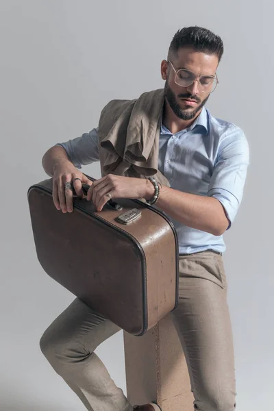 Cool Young Man Jacket Shoulder Holding Suitcase Thigh Looking Sitting — Stock Photo, Image