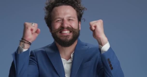 Blue Background Presenting Enthusiastic Young Man Holding Fists Air Screaming — Video