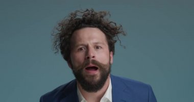 funny businessman on blue background talking in a crazy manner, making chatty hands gesture and having fun on blue background