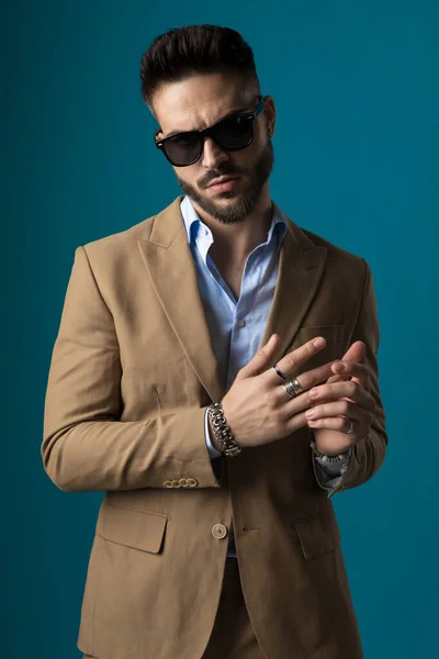 Dramatic Young Businessman Sunglasses Rubbing Touching Palms While Posing Beige — Stock Photo, Image