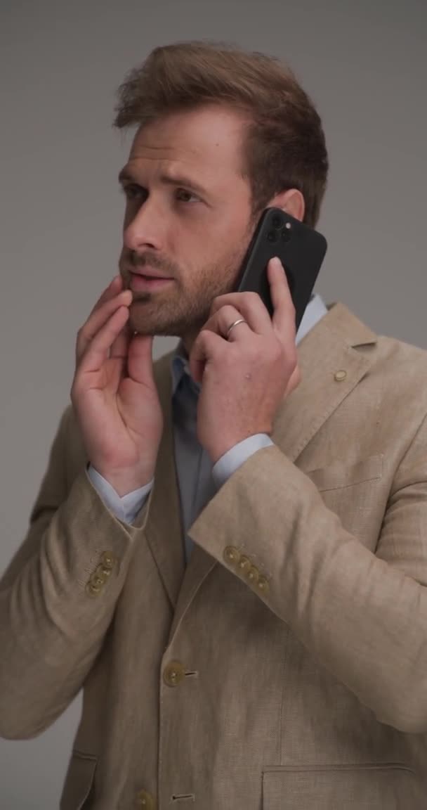 Jovem Preocupado Terno Elegante Falando Telefone Segurando Mão Atrás Pescoço — Vídeo de Stock