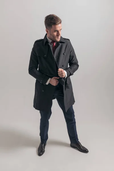 Cool Young Guy Suit Adjusting Closing Long Coat While Looking — Stock Photo, Image