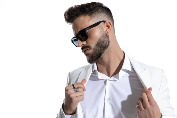 Seductive Young Businessman Sunglasses Opening Suit Looking White Background Studio — Stock Photo, Image