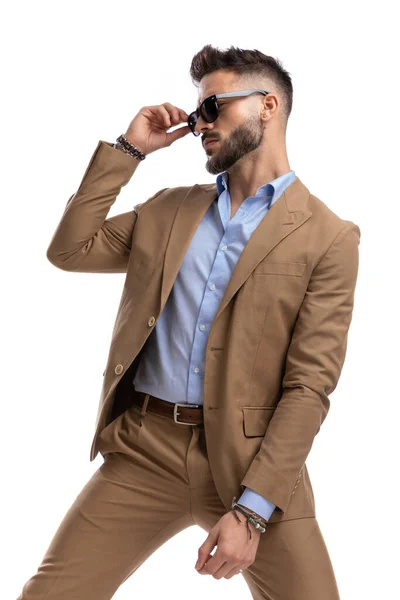 Portrait Attractive Young Guy Brown Suit Looking Side Adjusting Sunglasses — Stock Photo, Image