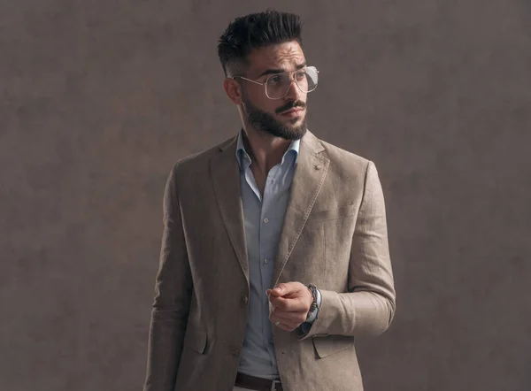 Sexy Bearded Businessman Eyeglasses Beige Suit Looking Side Posing Brown — стоковое фото