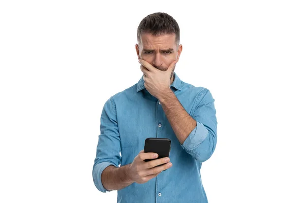 Retrato Jovem Chateado Cobrindo Boca Sendo Desapontado Segurar Telefone Fundo — Fotografia de Stock