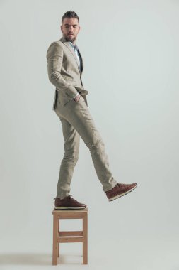 40 'lı yaşlarındaki bir adamın eski hayatını geride bırakması ve yeni fırsatlara adım atması, gri arka planda arkasını kollaması.