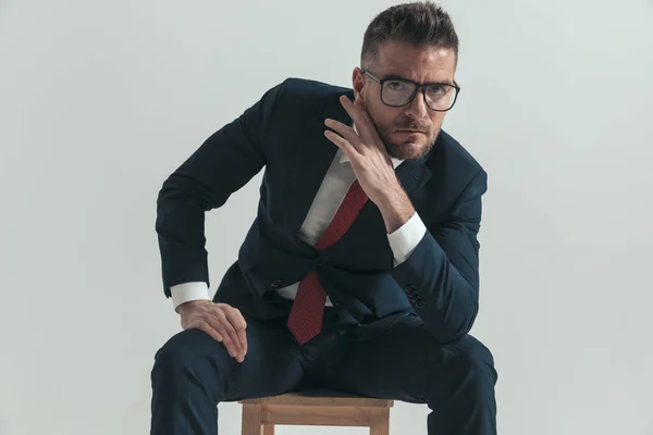 Attractive Businessman Beard Glasses Touching Face While Holding Palm Knee — Stock Photo, Image