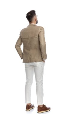 Bir iş adamının kollarını cebine sokup beyaz arka plana baktığı arka plan.