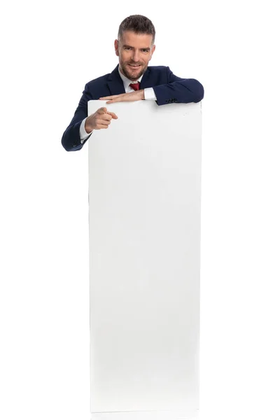 Geschäftsmann Zeigt Hinter Einer Leeren Plakatwand Vor Weißem Hintergrund Die — Stockfoto