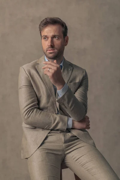Sexy Businessman Folding His Arms Looking Away Sitting Wooden Chair — Fotografia de Stock