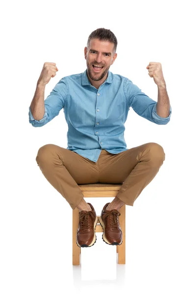 Excited Casual Guy Denim Shirt Beard Holding Fists Cheering While — Stock Photo, Image