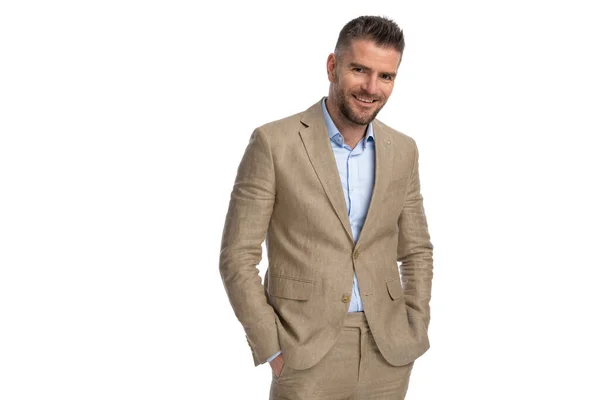 Portrait Handsome Businessman Beige Suit Hands Pockets Smiling Front White — Stockfoto