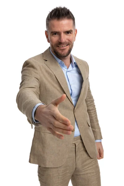 Unshaved Businessman Beige Suit White Background Smiling Shaking Hand Welcoming — Fotografia de Stock