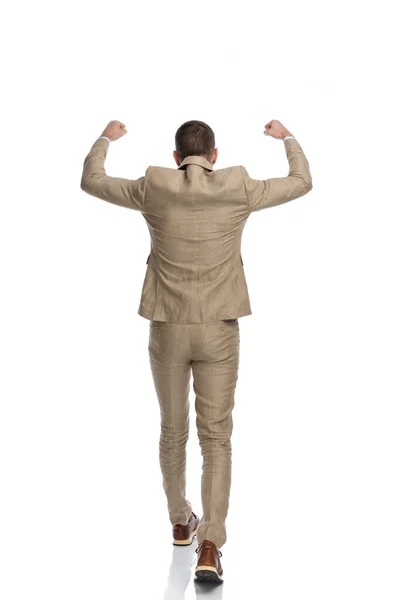 Back View Businessman Beige Suit Holding Arms Air Walking While —  Fotos de Stock