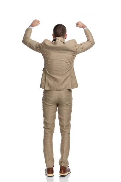 Happy Businessman Beige Suit Holding Arms Head Cheering Victory Being — 图库照片