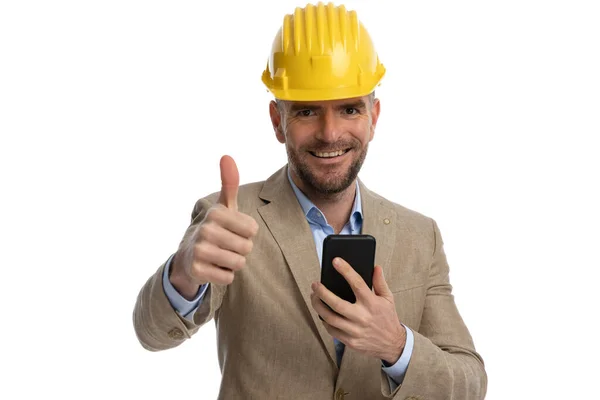 Portrait Smiling Businessman Beige Suit Holding Mobile Making Gesture Front — Stock Photo, Image
