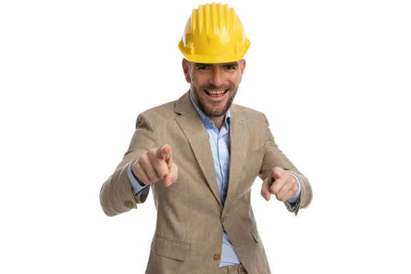 Attractive Businessman Beige Suit Helmet Pointing Fingers Laughing Front White — 图库照片