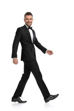 Mutlu iş adamı beyaz arka planda kameraya gülümsüyor.