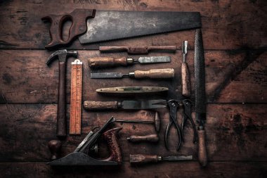vintage collection of old carpentry tools with hammer, file, planer, pincers, crowbar and other illustrating concept of craftsmanship