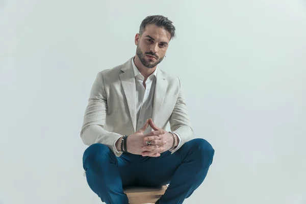 Portrait Confident Businessman Beard Crossing Fingers Sitting Wooden Chair Grey — Fotografia de Stock