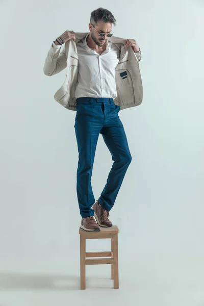 Sexy Bearded Man Glasses Looking Adjusting Jacket While Standing Wooden — Stockfoto