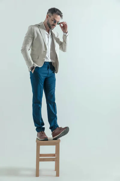 Attractive Man Smart Casual Outfit Looking His Sneakers Fixing Sunglasses — Foto de Stock