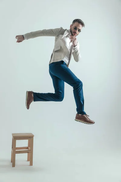 Full Body Picture Bearded Businessman Glasses Jumping Wooden Chair Touching — Foto Stock