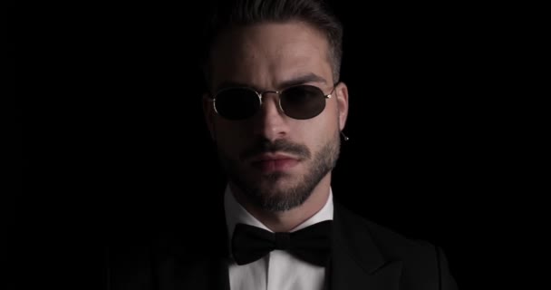 Unshaved Young Groom Wearing Sunglasses Looking Side Arranging Bowtie Smiling — Vídeo de stock