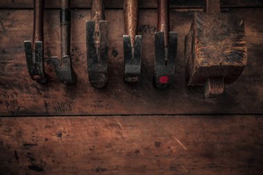 table view of set of vintage woodworking tools on a rough workbench with blank space below