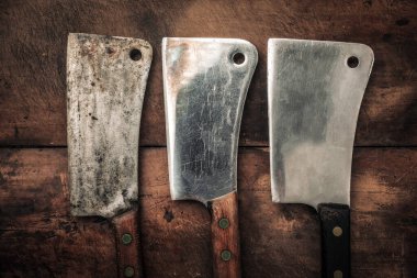 table top picture of three vintage cleavers for meat chopping with sharp blade, kitchen knife concept 