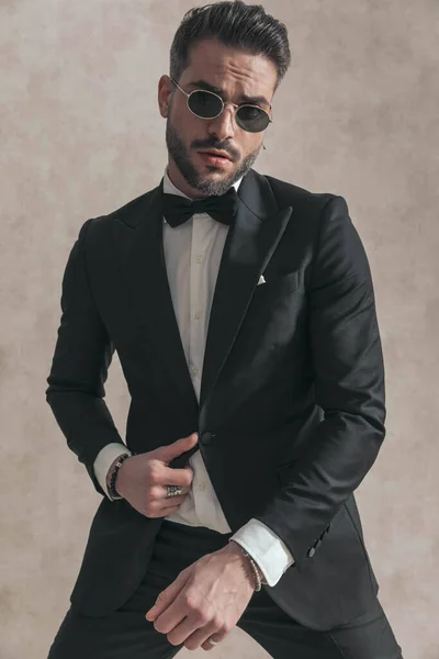 Portrait Fashion Elegant Guy Adjusting Black Tuxedo Posing Front Beige — Stock Photo, Image